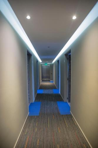an empty corridor with blue lighting in an office building at ÑU Posta Urbana Hotel Boutique in Cordoba