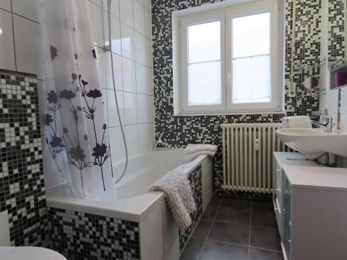 een badkamer met een bad en een wastafel bij Ferienwohnung Berndes in Meersburg
