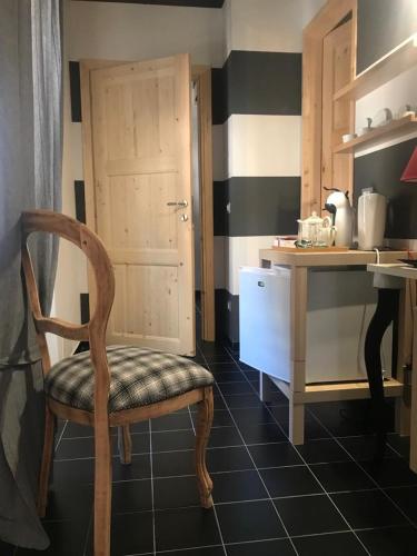 a kitchen with a chair and a table and a counter at Sanctus Syrus 2 in Albenga