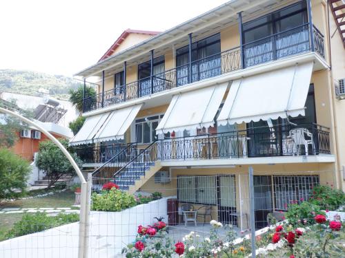 an apartment building with balconies and flowers at Gardelis Gardens in Benitses