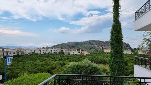 a view of a city from the balcony of a house at D&D apartments in Ancient Epidavros