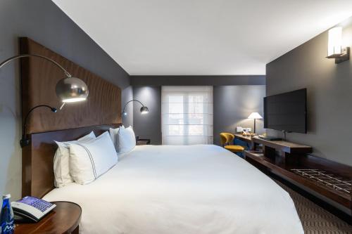 a hotel room with a large bed and a television at Sofitel Bogota Victoria Regia in Bogotá