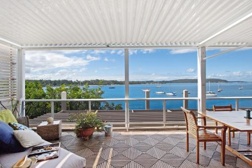 a screened in porch with a view of the water at Bay Breeze Boutique Accommodation in Batemans Bay