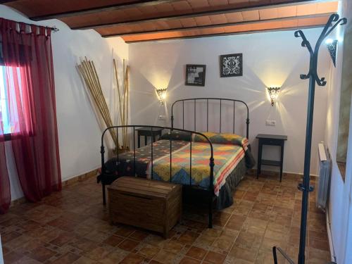 a bedroom with a bed in a room at Cortijo Rural La Chula in Fontanar
