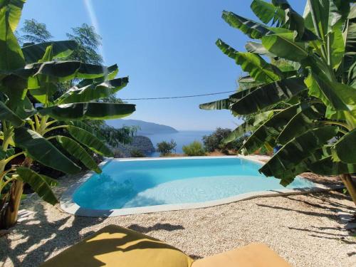 a swimming pool in a villa with a view of the ocean at Mandala Camping in Faralya