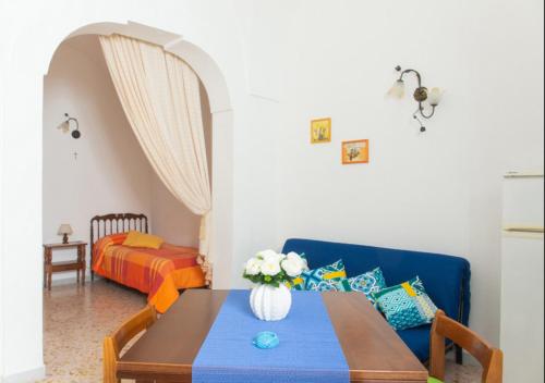 - un salon avec une table et un canapé dans l'établissement Casa Rosetta con terrazza panoramica by Wonderful Italy, à Ostuni