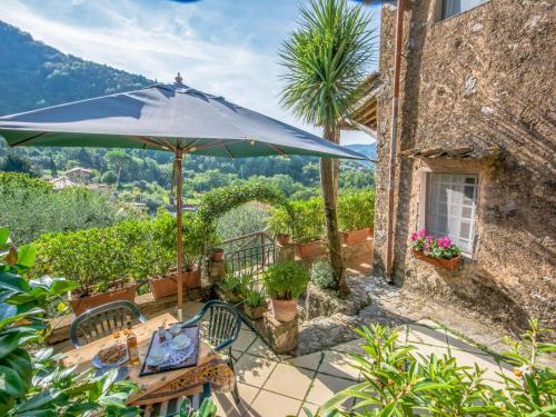 a patio with an umbrella and a table and chairs at Holiday Home Il Metatino by Interhome in Montemagno