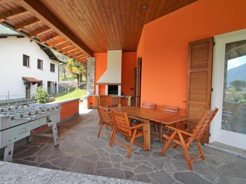 a wooden table and chairs on a patio at Villa Lenno by Interhome in Lenno