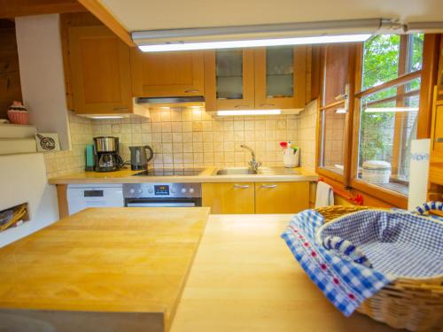 a kitchen with wooden cabinets and a counter top at Chalet Waldner by Interhome in Thannrain
