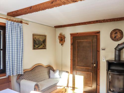 a living room with a couch and a fireplace at Chalet Weissenbach by Interhome in Weissenbach