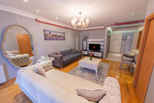 a living room with a couch and a table at CTS Elysium Residence Taksim in Istanbul