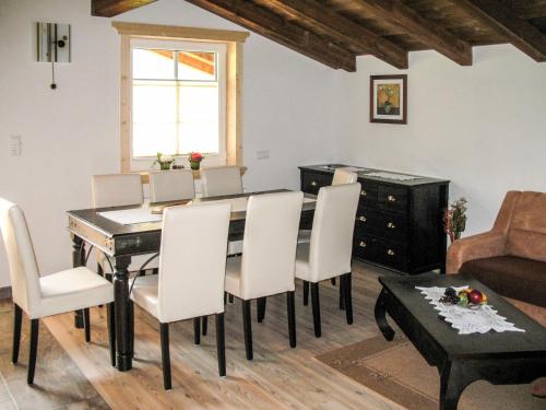 a dining room with a table and chairs and a couch at Apartment Rieser - NIT130 by Interhome in Umhausen