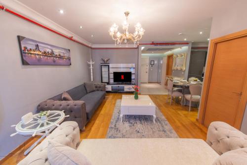 a living room with a couch and a table at CTS Elysium Residence Taksim in Istanbul