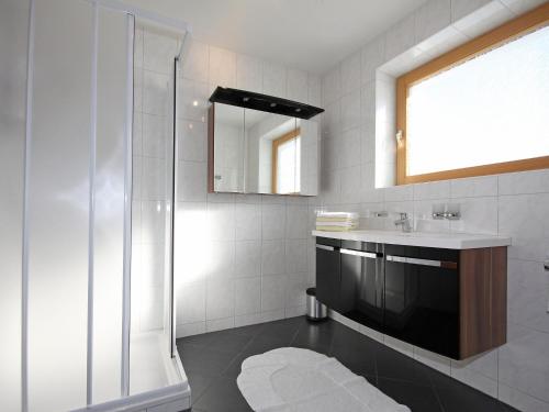 a bathroom with a shower and a sink and a mirror at Apartment Obernberg by Interhome in Obernberg am Brenner
