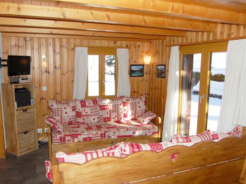 a log cabin with a bed and a living room at Chalet Coucordin by Interhome in Nendaz