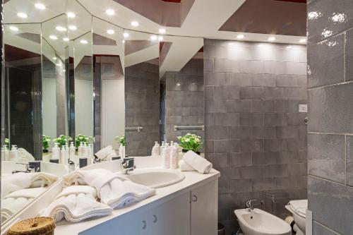 a bathroom with two sinks and a large mirror at Luxury apartment in the heart of Genoa by Wonderful Italy in Genova