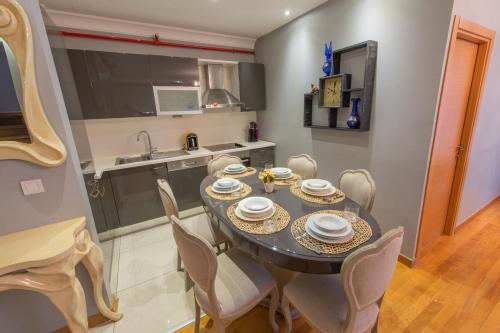 a kitchen and dining room with a table and chairs at CTS Elysium Residence Taksim in Istanbul