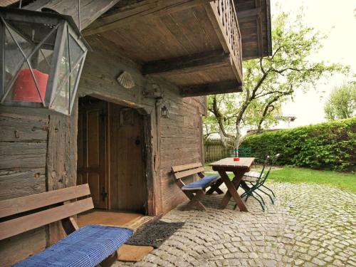 a wooden cabin with a picnic table and a bench at Chalet Troadkasten by Interhome in Neuhofen im Innkreis