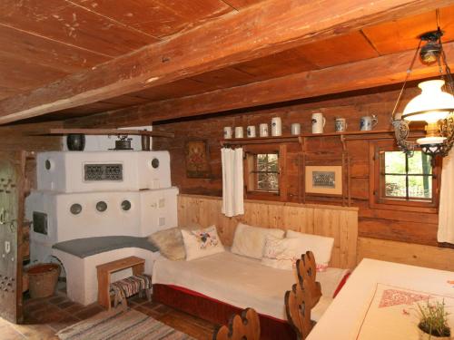 a living room with a couch and a stove at Chalet Troadkasten by Interhome in Neuhofen im Innkreis