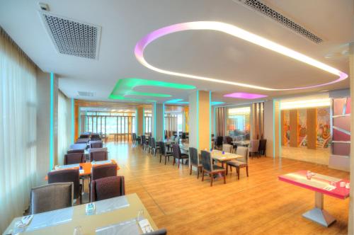 a waiting room with tables and chairs in a building at One One Bangkok in Bangkok