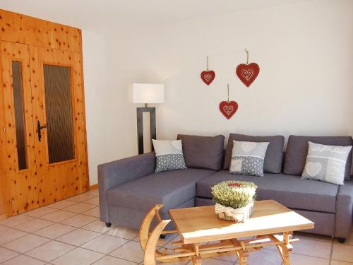 a living room with a couch and a table at Apartment Christiania 2 C8 by Interhome in Nendaz