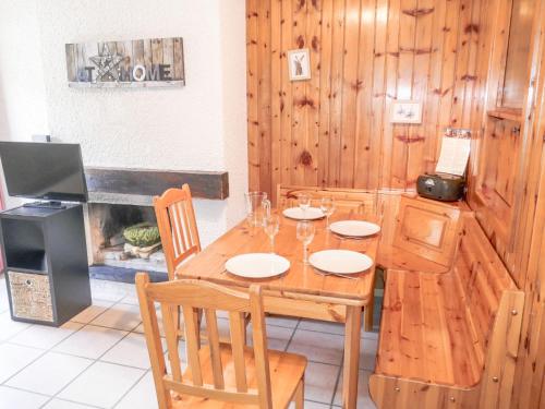 a dining room with a table and chairs and a fireplace at Apartment Christiania 2 C8 by Interhome in Nendaz