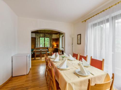 a dining room with a long table and chairs at Holiday Home Riki by Interhome in Bruck an der Großglocknerstraße