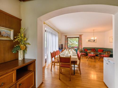 a kitchen and dining room with a table and chairs at Holiday Home Riki by Interhome in Bruck an der Großglocknerstraße