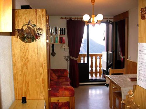 a living room with a view of a balcony at Apartment Val d'Huez by Interhome in L'Alpe-d'Huez