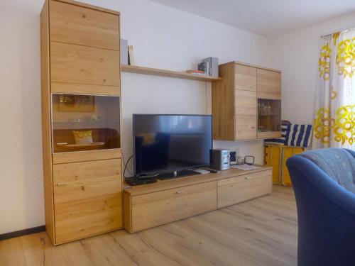 a living room with a tv on a wooden entertainment center at Apartment Viscaria-1 by Interhome in Zermatt