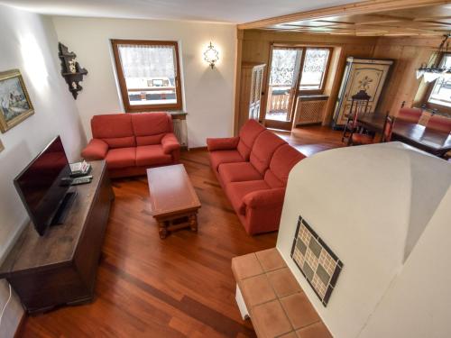 an overhead view of a living room with red furniture at Chalet Cesa Galadriel-1 by Interhome in Penia