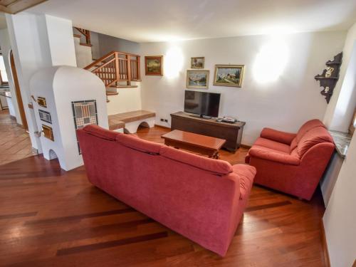 a living room with a couch and a table at Chalet Cesa Galadriel-1 by Interhome in Penia