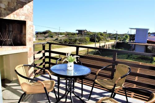 a table and chairs on a balcony with a view at Puertas De La Serena in La Paloma