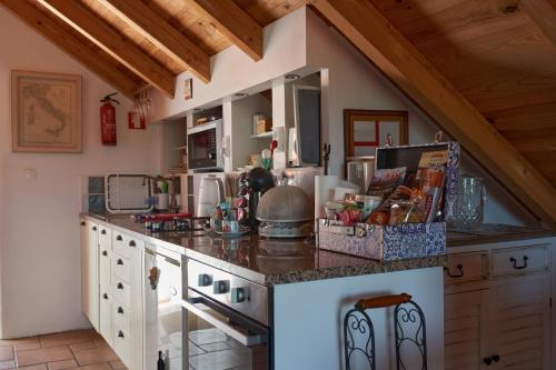 a kitchen with a counter top in a room at Quinta do Bom Vento in Óbidos