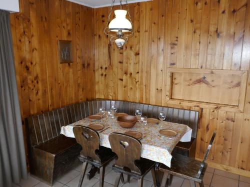 a dining room with a table and chairs and wooden walls at Apartment Christiania I F4 by Interhome in Nendaz