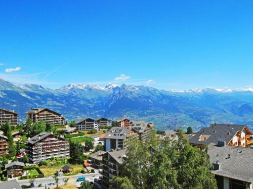 a view of a city with mountains in the background at Apartment Les Chouettes 22 by Interhome in Nendaz