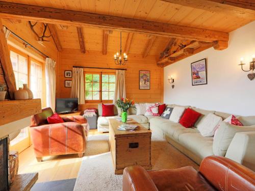 a living room with a couch and a table at Chalet Saint Piran-1 by Interhome in Villars-sur-Ollon
