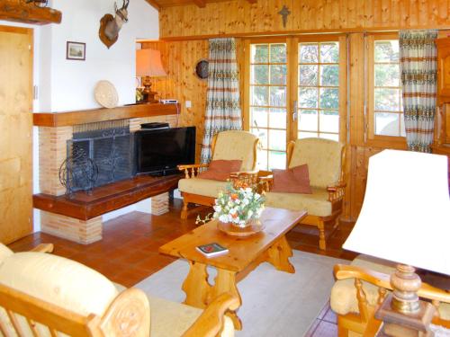 a living room filled with furniture and a fireplace at Chalet Dejo A Dzeu by Interhome in Nendaz