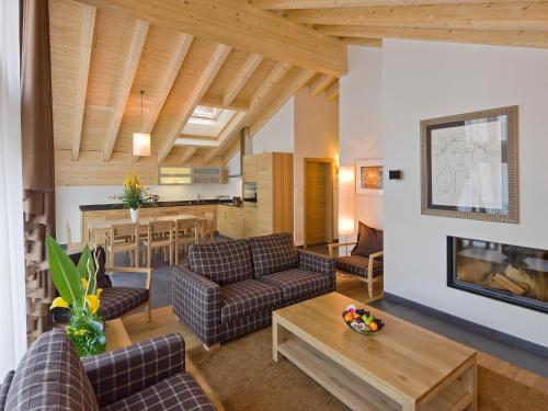 a living room with two couches and a table at Apartment Zur Matte B-11 by Interhome in Zermatt