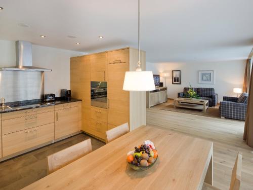 a kitchen and a table with a bowl of fruit on it at Apartment Zur Matte B-8 by Interhome in Zermatt