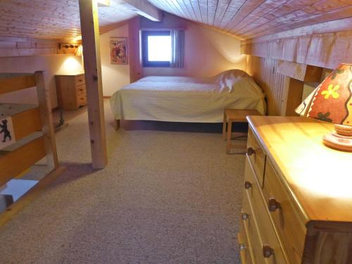 a bedroom with a bed in a small room at Apartment Arsets 203-12 by Interhome in Arveyes