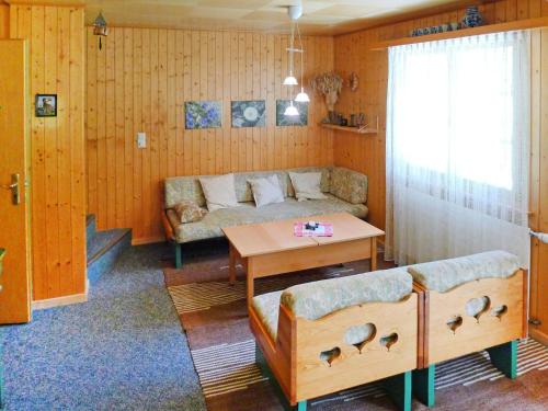 ein Wohnzimmer mit einem Sofa und einem Tisch in der Unterkunft Chalet Allegra by Interhome in Grächen