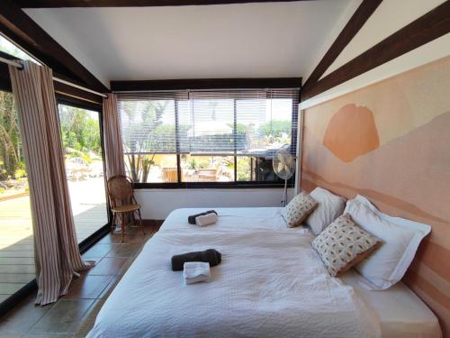 a bedroom with a large bed and a large window at MerSea Beach House in Sainte-Maxime in La Nartelle