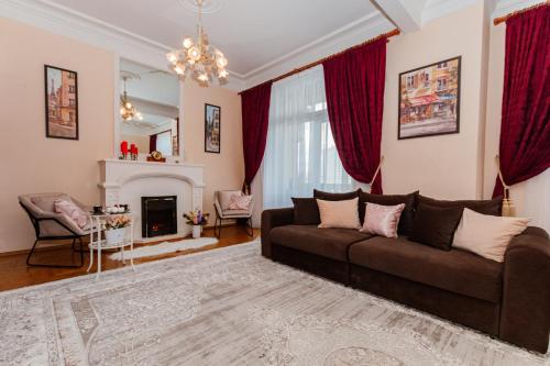 a living room with a couch and a fireplace at Lakshmi Club Apartment 3-bedroom in Moscow