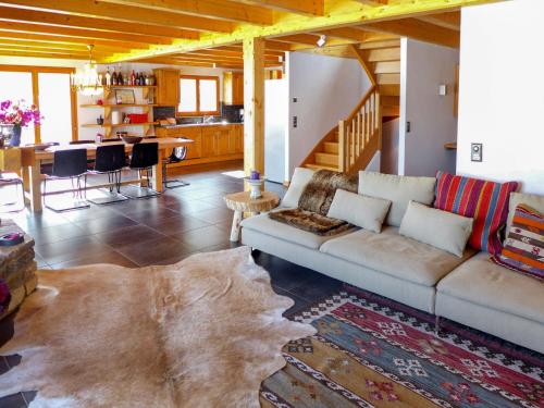 a living room with a couch and a table at Chalet Bredius by Interhome in Bluche