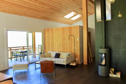 a living room with a couch and a fireplace at Modern Chalet With Garden Chamonix in Chamonix-Mont-Blanc