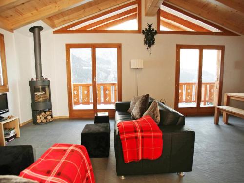 a living room with a couch and a wood stove at Chalet Chloé by Interhome in Ovronnaz