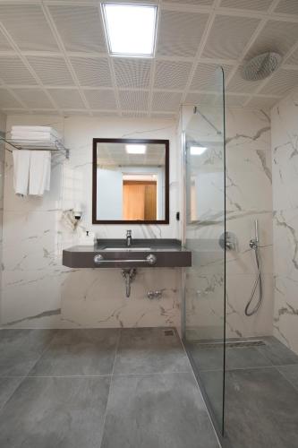 a bathroom with a sink and a mirror at Belcehan Hotel in Oludeniz