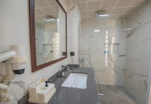 a bathroom with a sink and a mirror at Belcehan Hotel in Oludeniz
