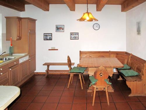 a kitchen with a wooden table and a table and chairs at Holiday Home Ilztal by Interhome in Allmunzen